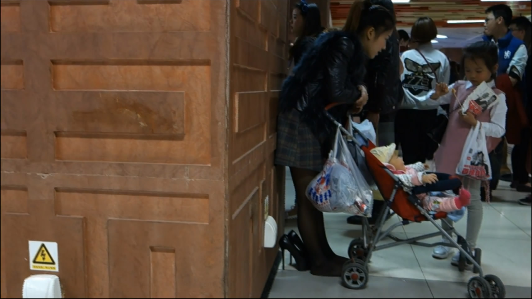 Young Woman Take Care Her Siblings in Crowded Places